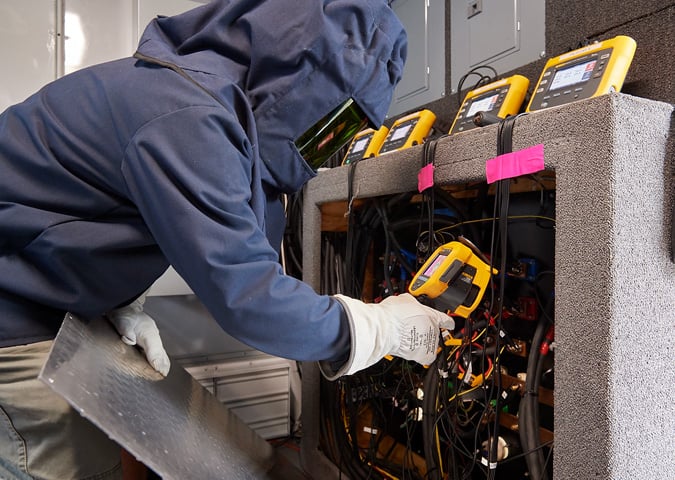 A UPS technician inspects the trailer’s electrical panel with a Fluke Ti400 Infrared Camera.