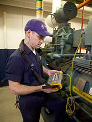 A technician reads data from the Fluke 810 Vibration Tester