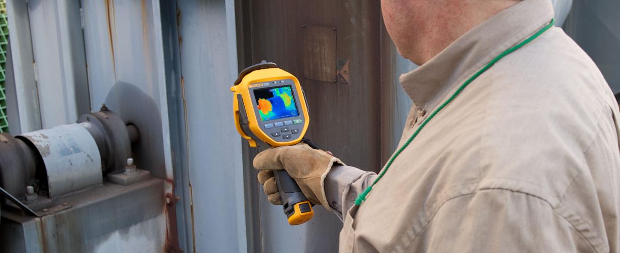 A thermal imaging expert examines equipment with a Fluke Infrared Camera