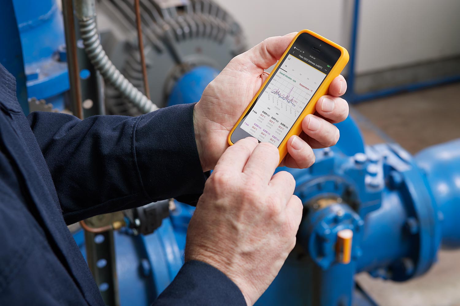 Personnel using the Fluke Connect app to check data from their smart device.