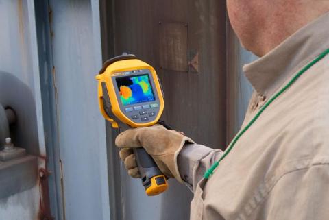 A thermal imaging expert examines equipment with a Fluke Infrared Camera