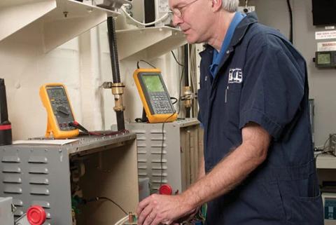 Technician Comparing an Oscilloscope Vs. a Multimeter